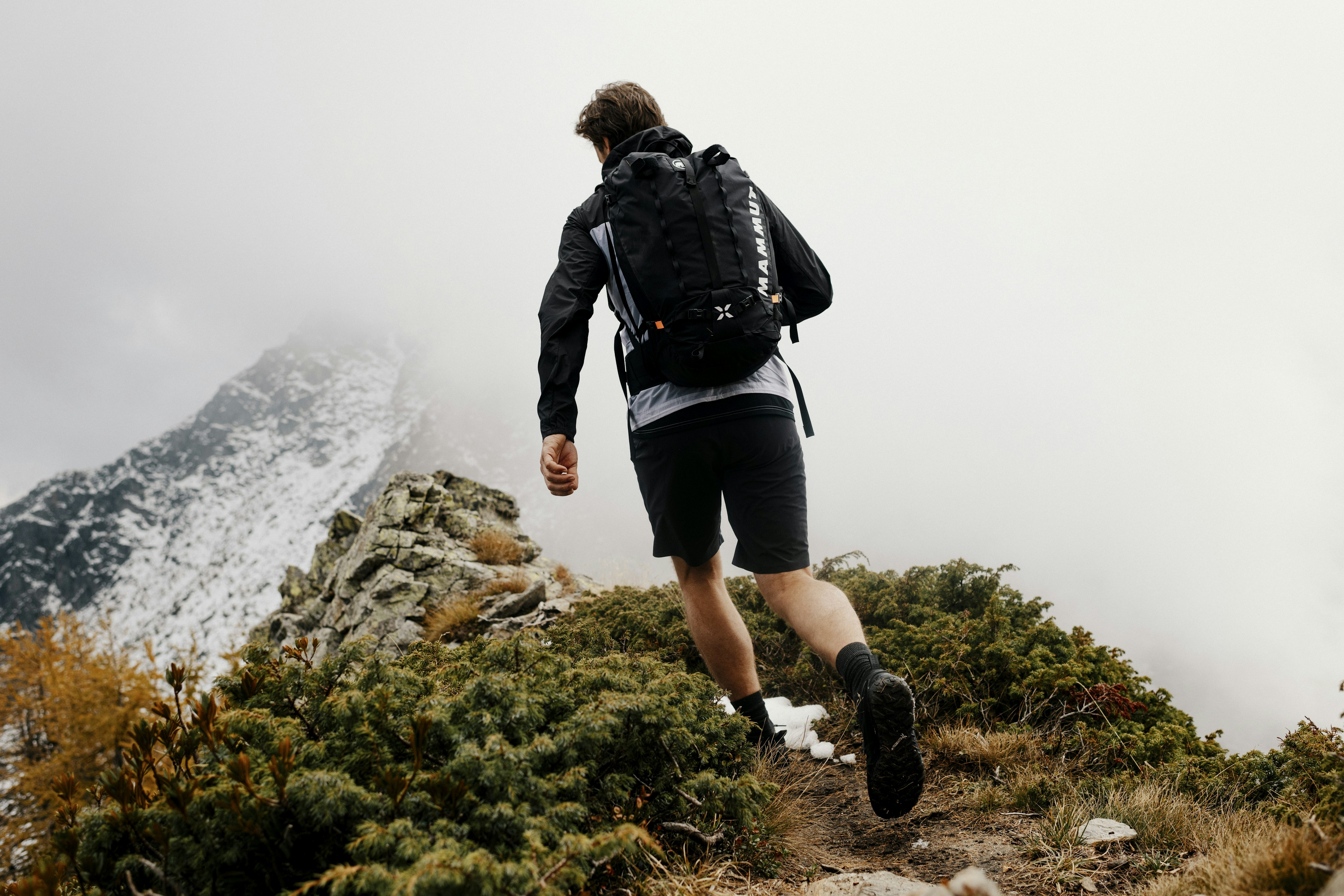 Man walking with backpack on a mountain