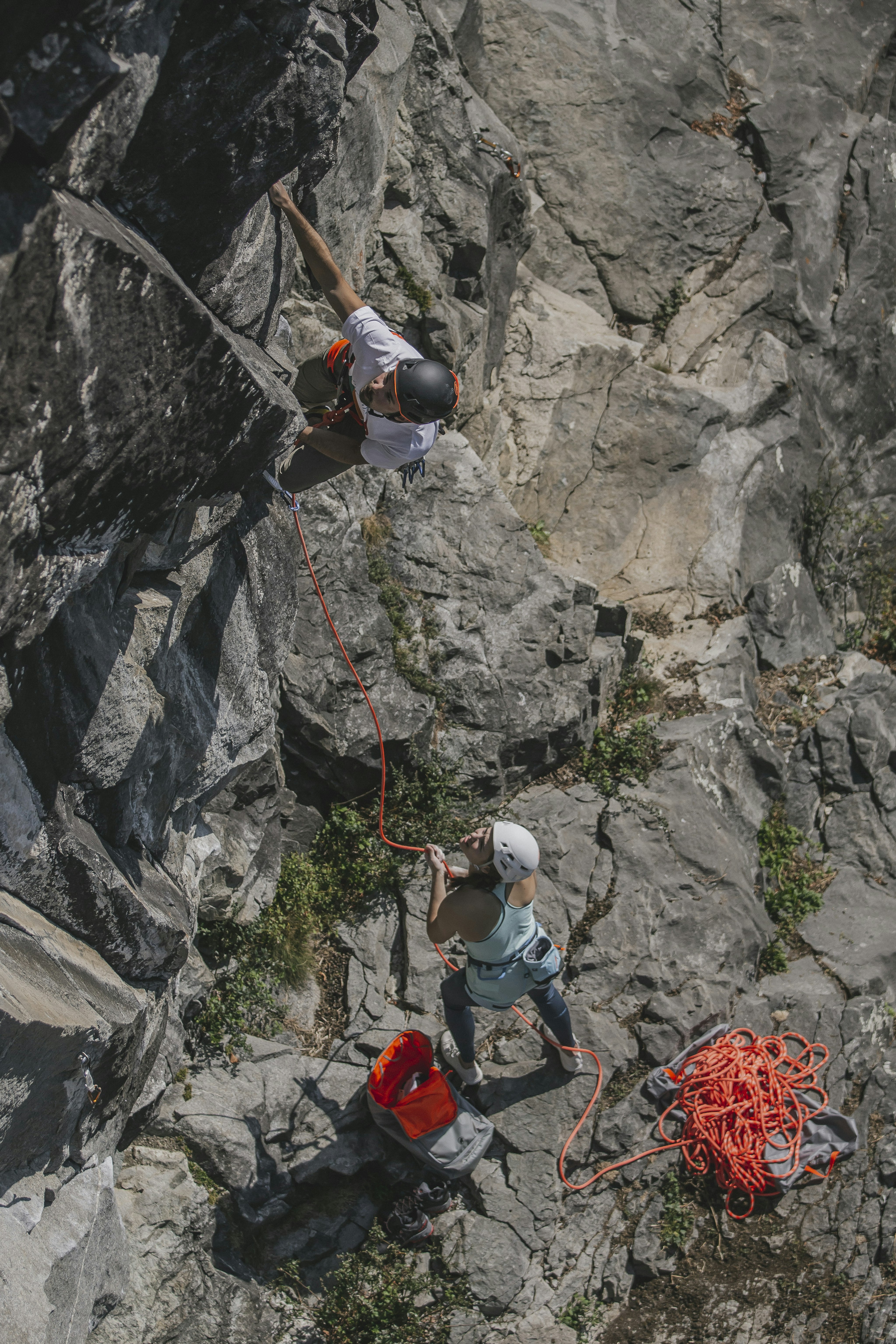 Man and woman climbing on a rock wall