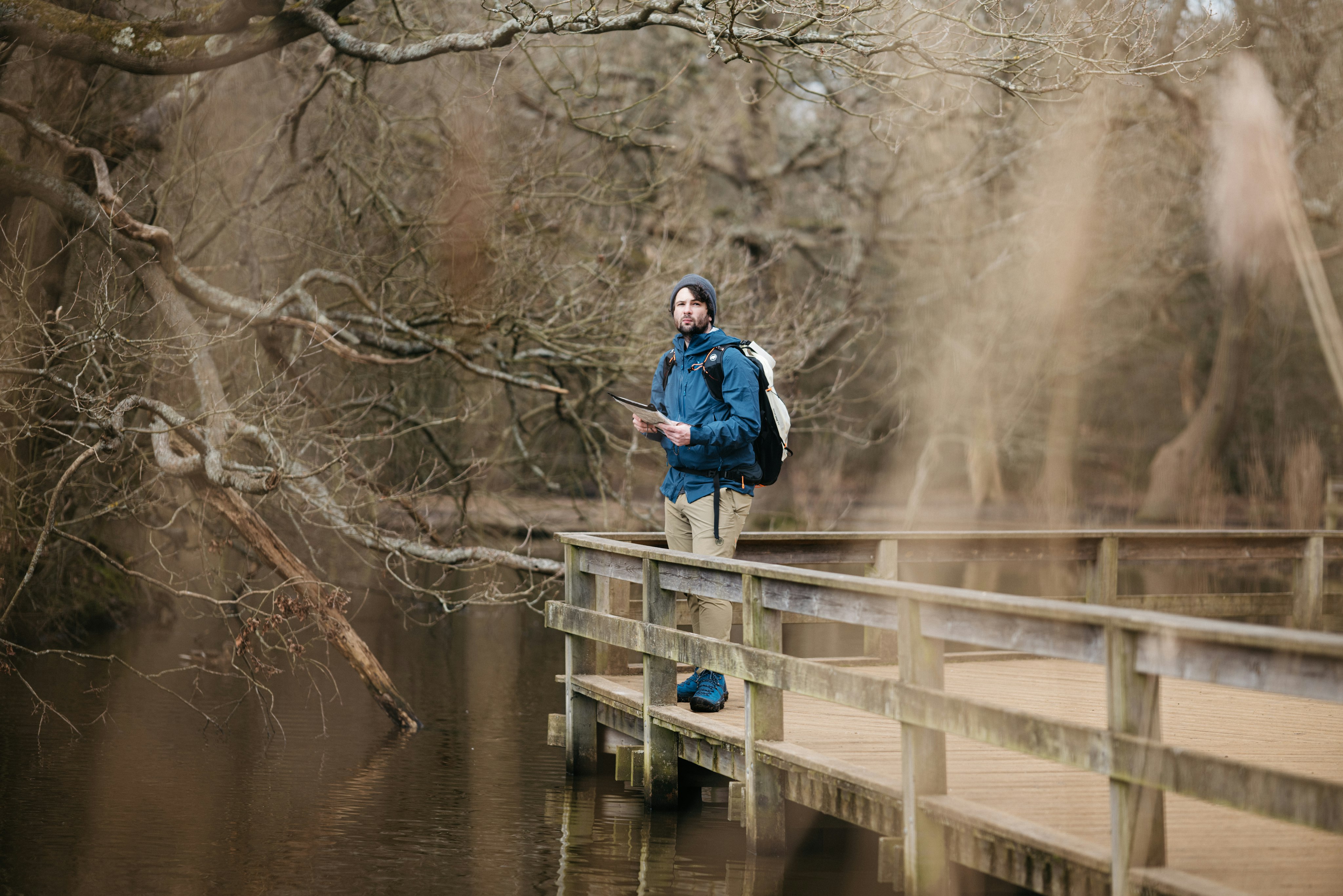 Man on a footbridge in the forest