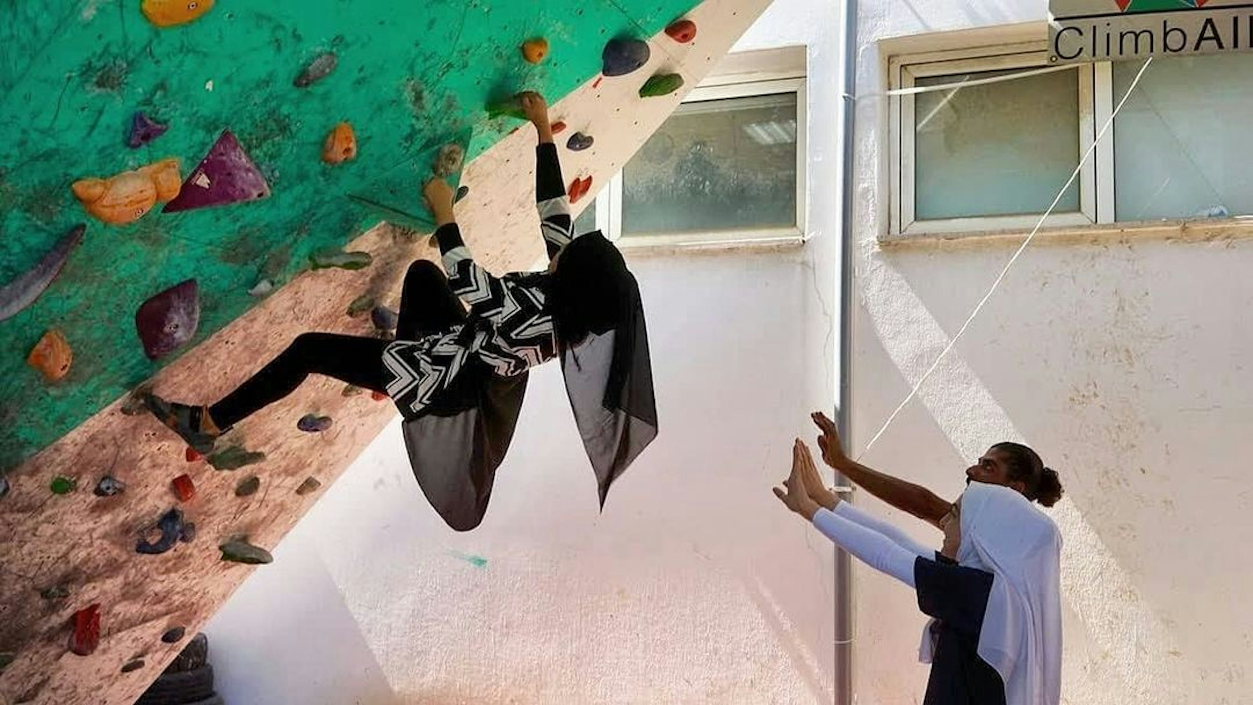 A person bouldering on a bouldering wall