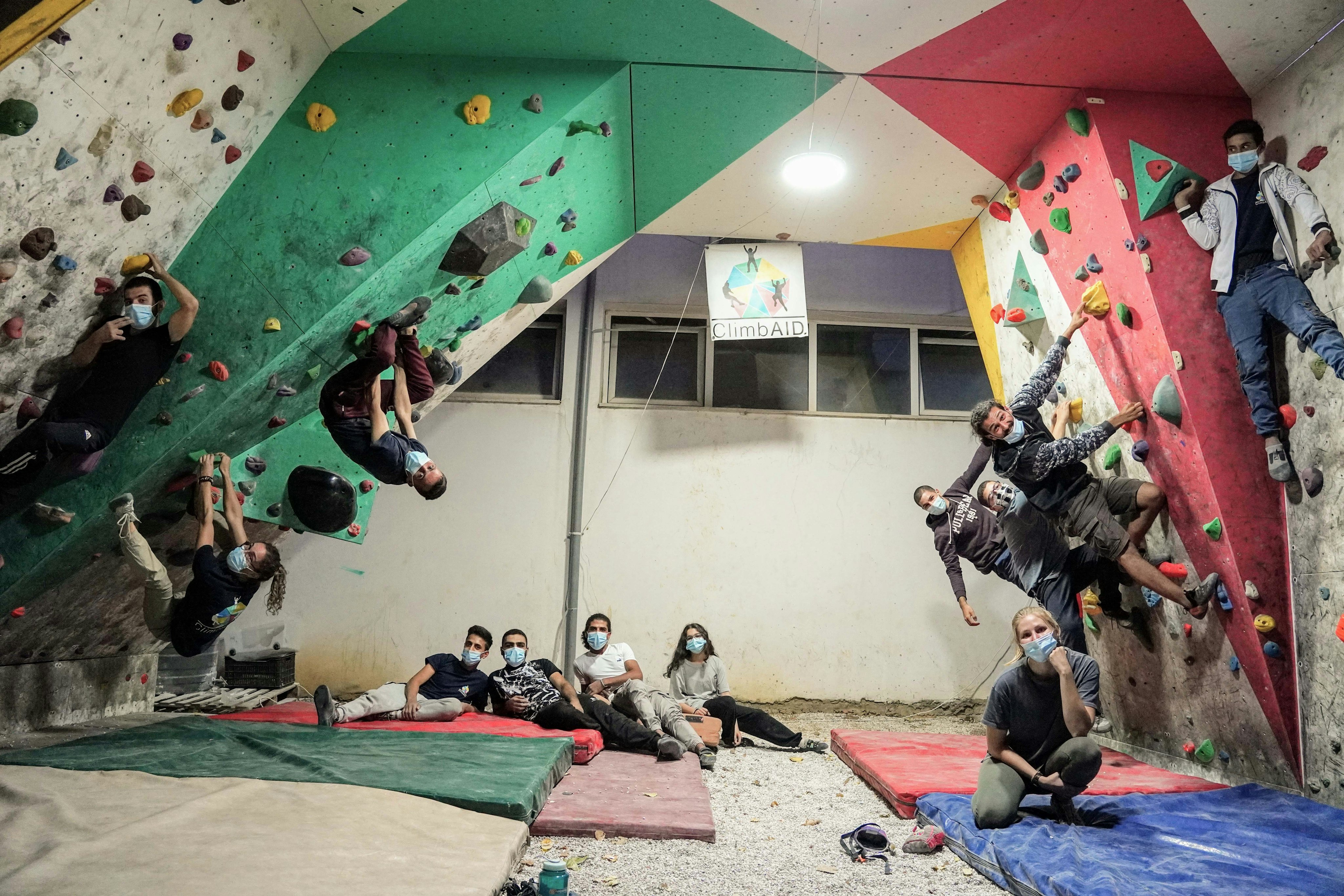 A group photo of people in a bouldering room.
