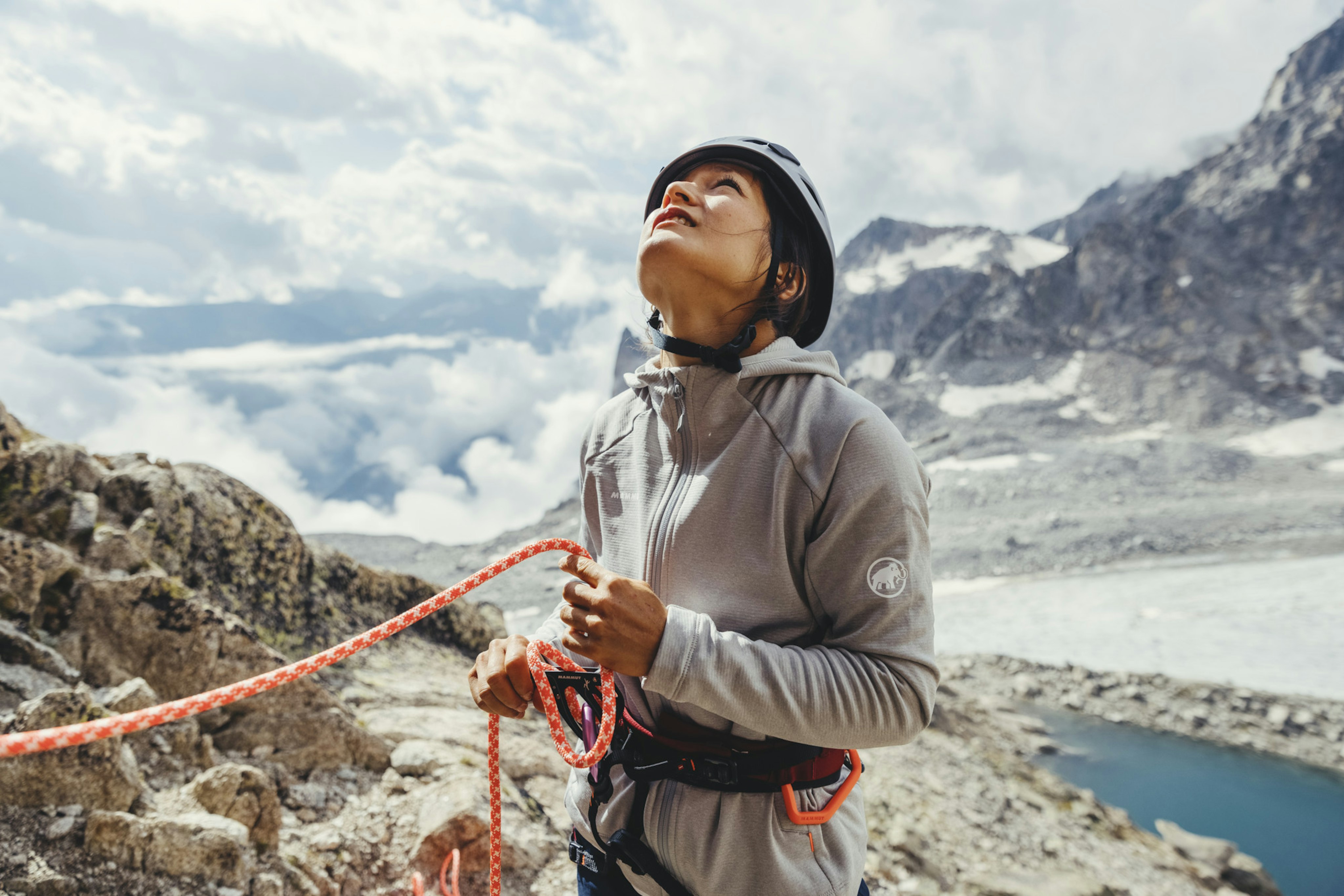 Climber in gray Mammut jacket with orange rope