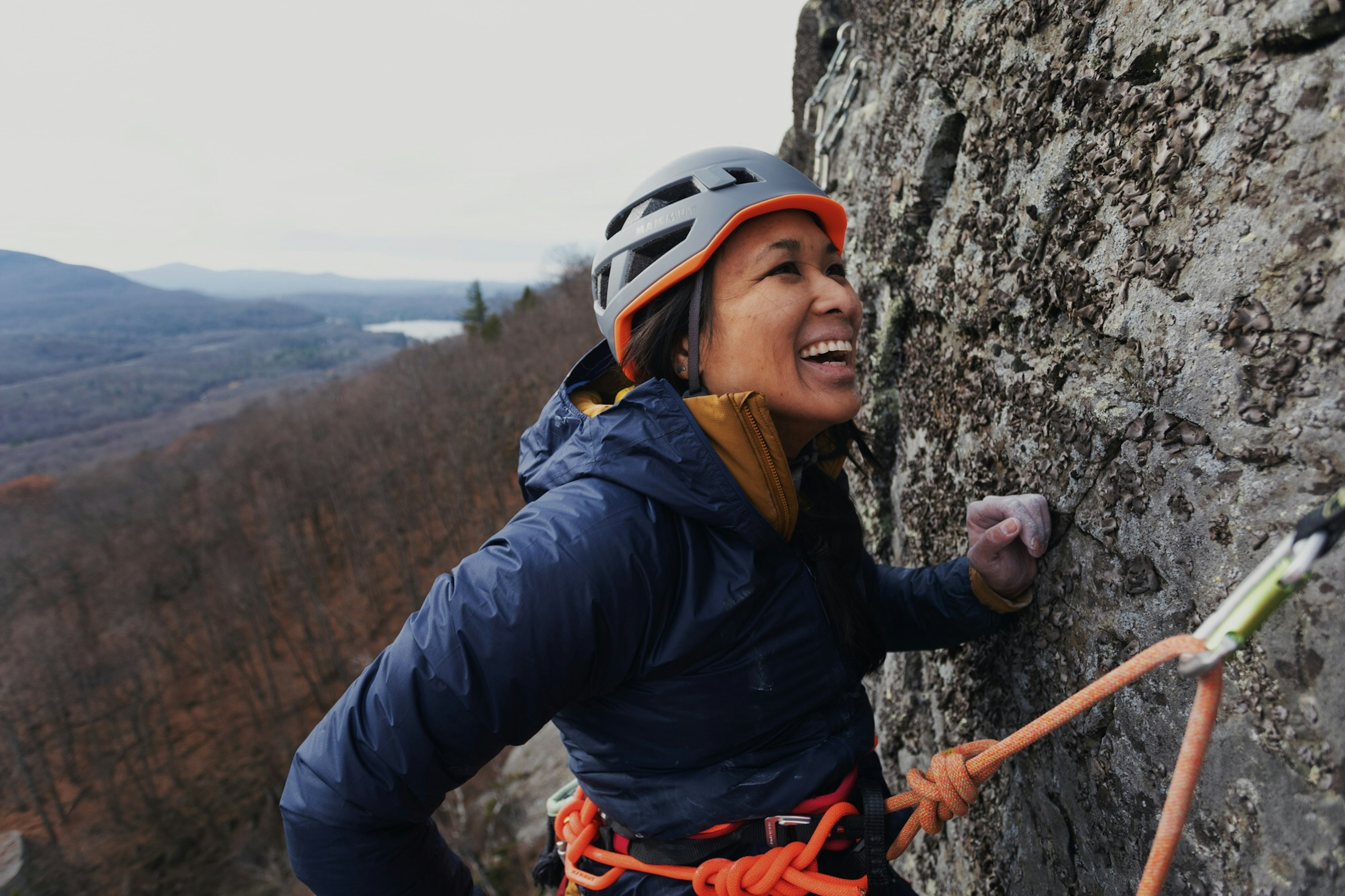 Laughing woman is climbing 