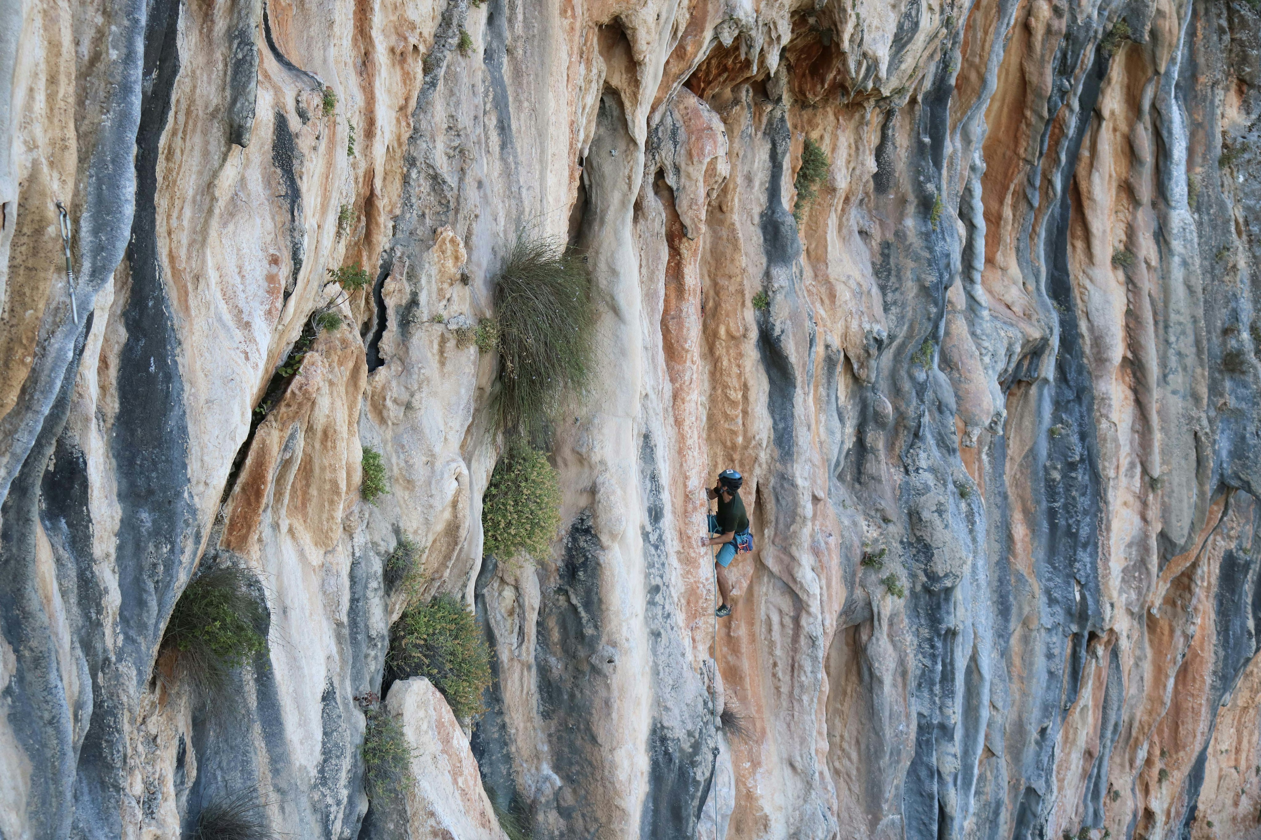 A man climbing a rock face in Lebanon.