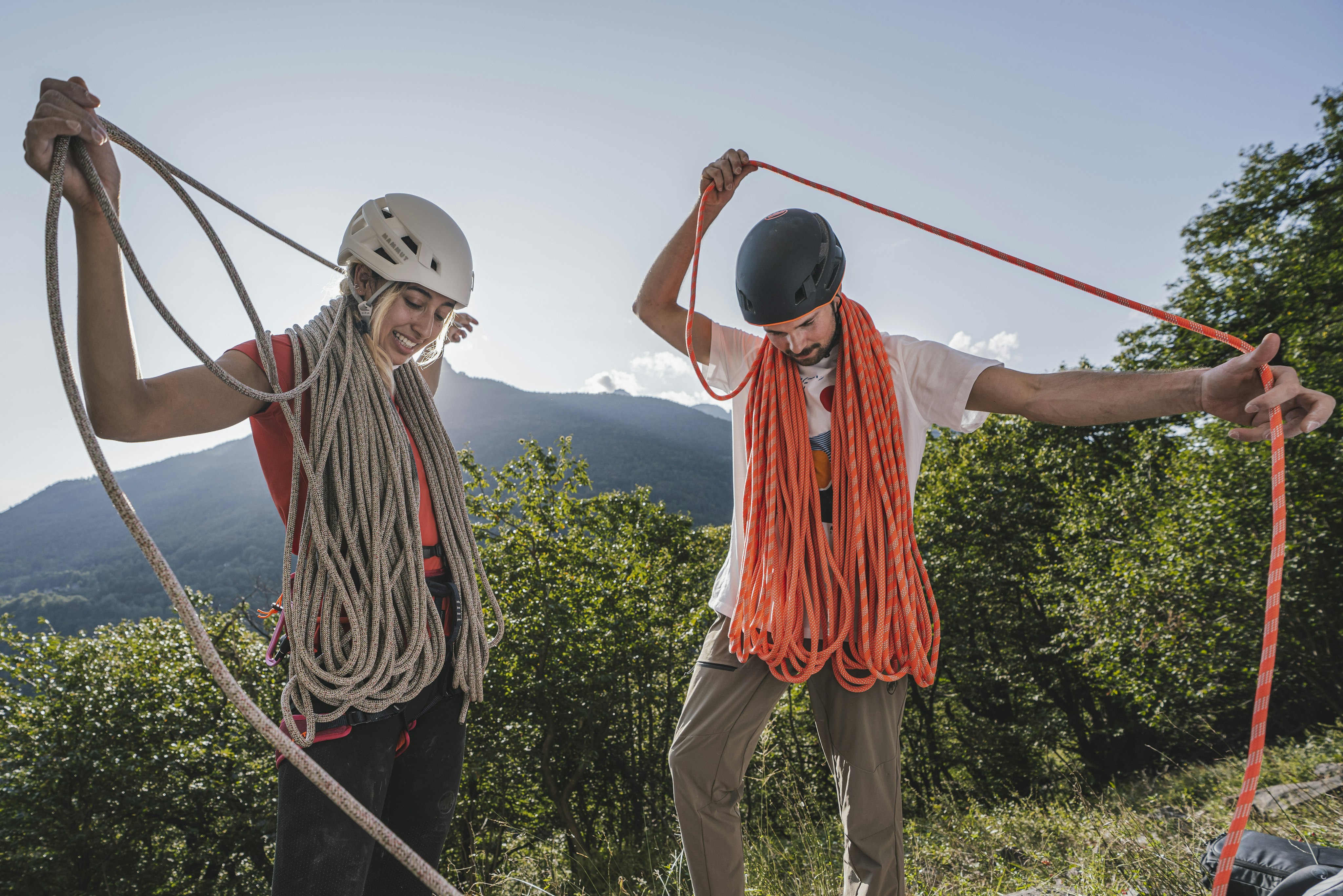 Two climbers prepare their ropes.