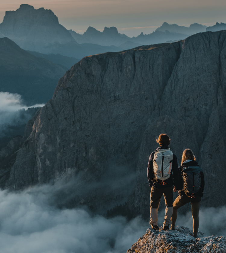 Two people standing on a mountain